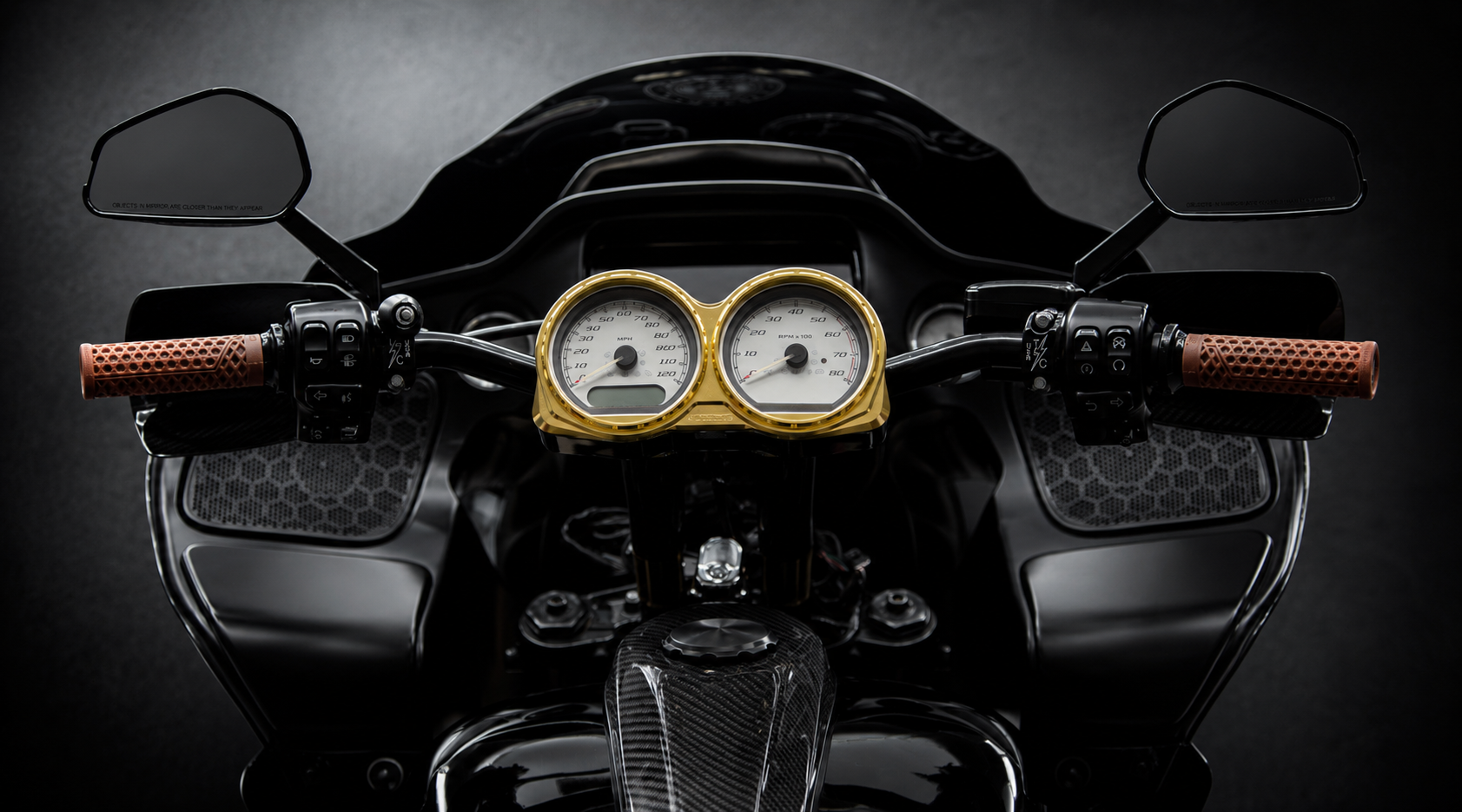 Photo by Anthony Mojica. RF7 Carbon Fiber Dual Gauge Bezel shown with light gold gauge rings. Gauges not included; designed to work with stock gauges on 2014-2023 Road Glide models.