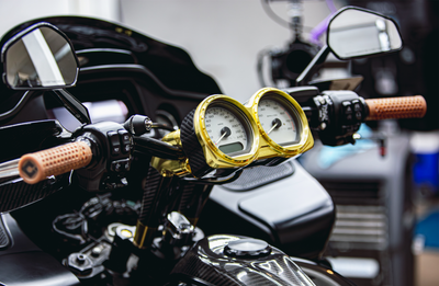 Photo by Anthony Mojica. RF7 Carbon Fiber Dual Gauge Bezel shown with light gold gauge rings. Gauges are not included; designed to work with stock gauges on 2014-2023 Road Glide models.