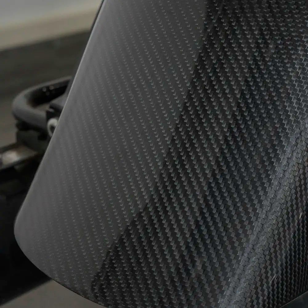 Close-up of the glossy carbon fiber weave on a SuperGear rear fender for Harley-Davidson Road Glide.