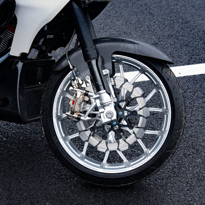 24+ road glide cvo st forged front wheel setup with a machined wheel hub and performance brake rotors.